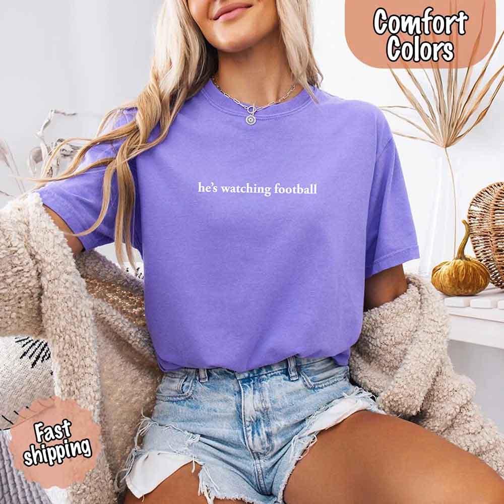 He’s Watching Football Tee - Comfort Colors Funny Shirt for Her