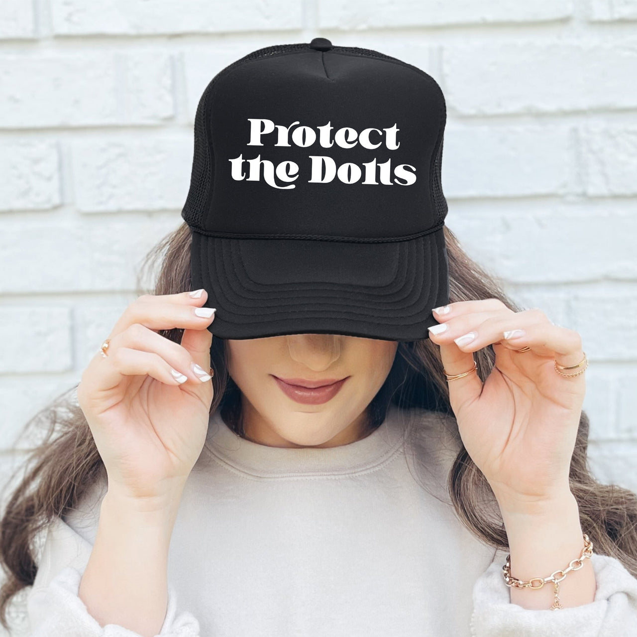 Protect The Dolls Bold Slogan Graphic For Real Talk Style Enthusiasts And Trendsetters Trucker Hat