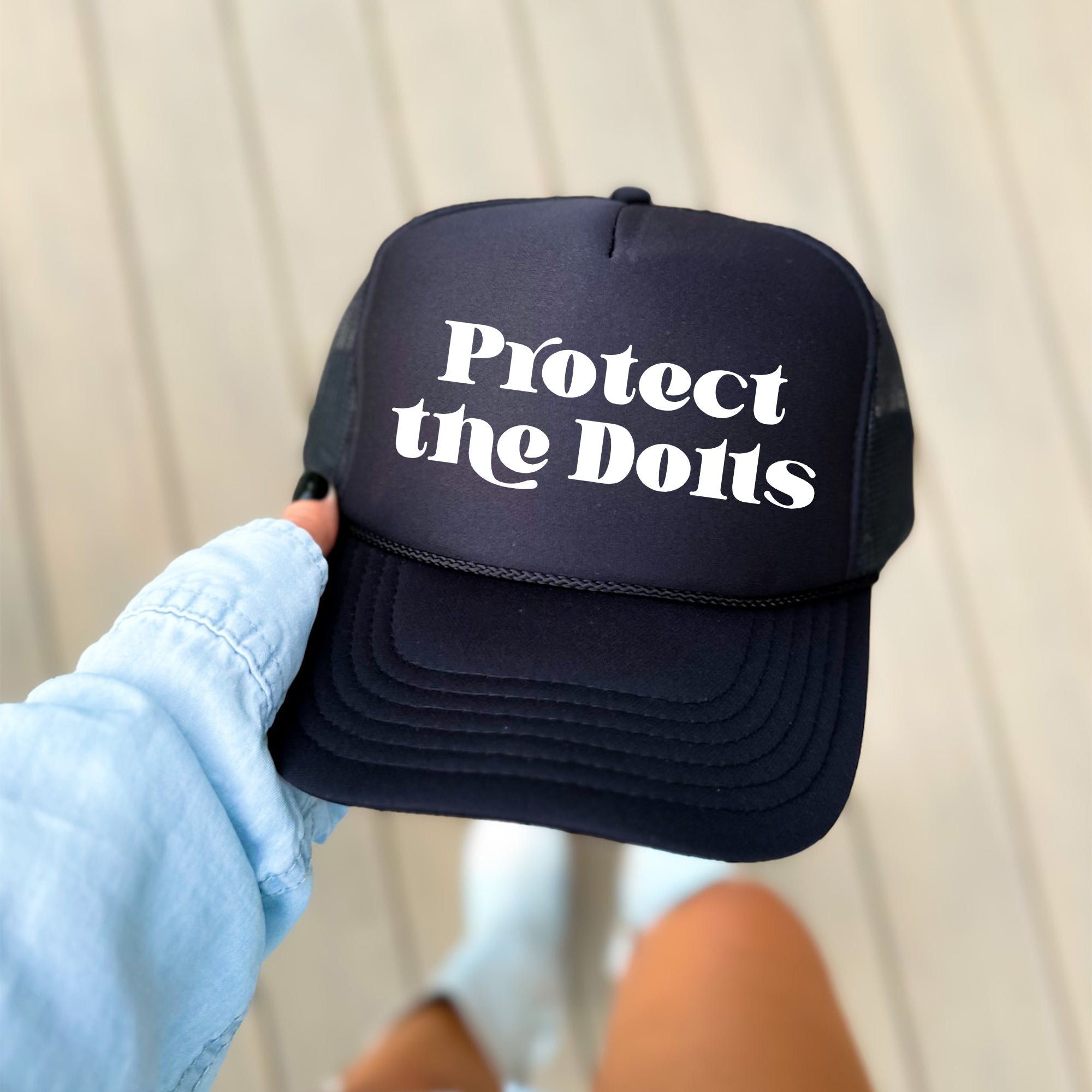 Protect The Dolls Bold Slogan Graphic For Real Talk Style Enthusiasts And Trendsetters Trucker Hat